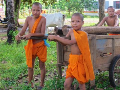 Children monks with a cart