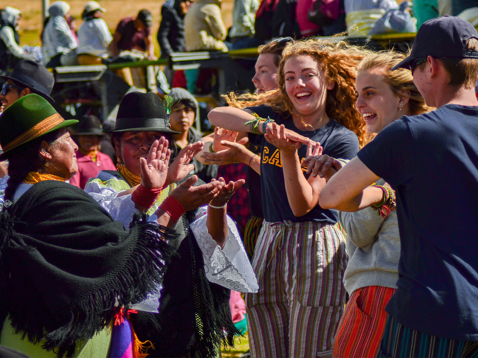 travellers and locals dancing together