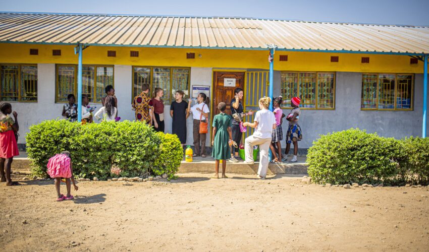 Travellers interacting with school community.