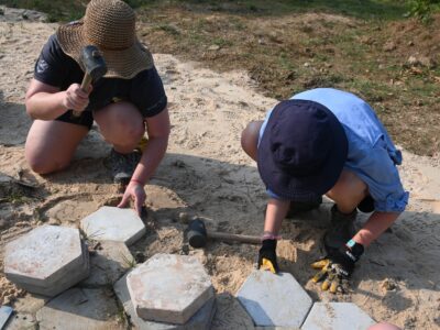 Travellers working on a Concrete Pathway in Cambodia.