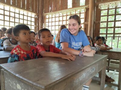 Traveller sitting in a English class with school children in Cambodia.