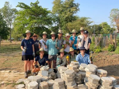Travellers with building tools on project work in Cambodia.