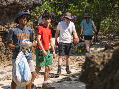 Guys litter picking on a beach