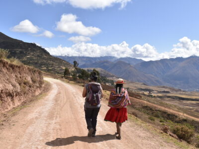 Travelling Student and Peruvian women walking along road