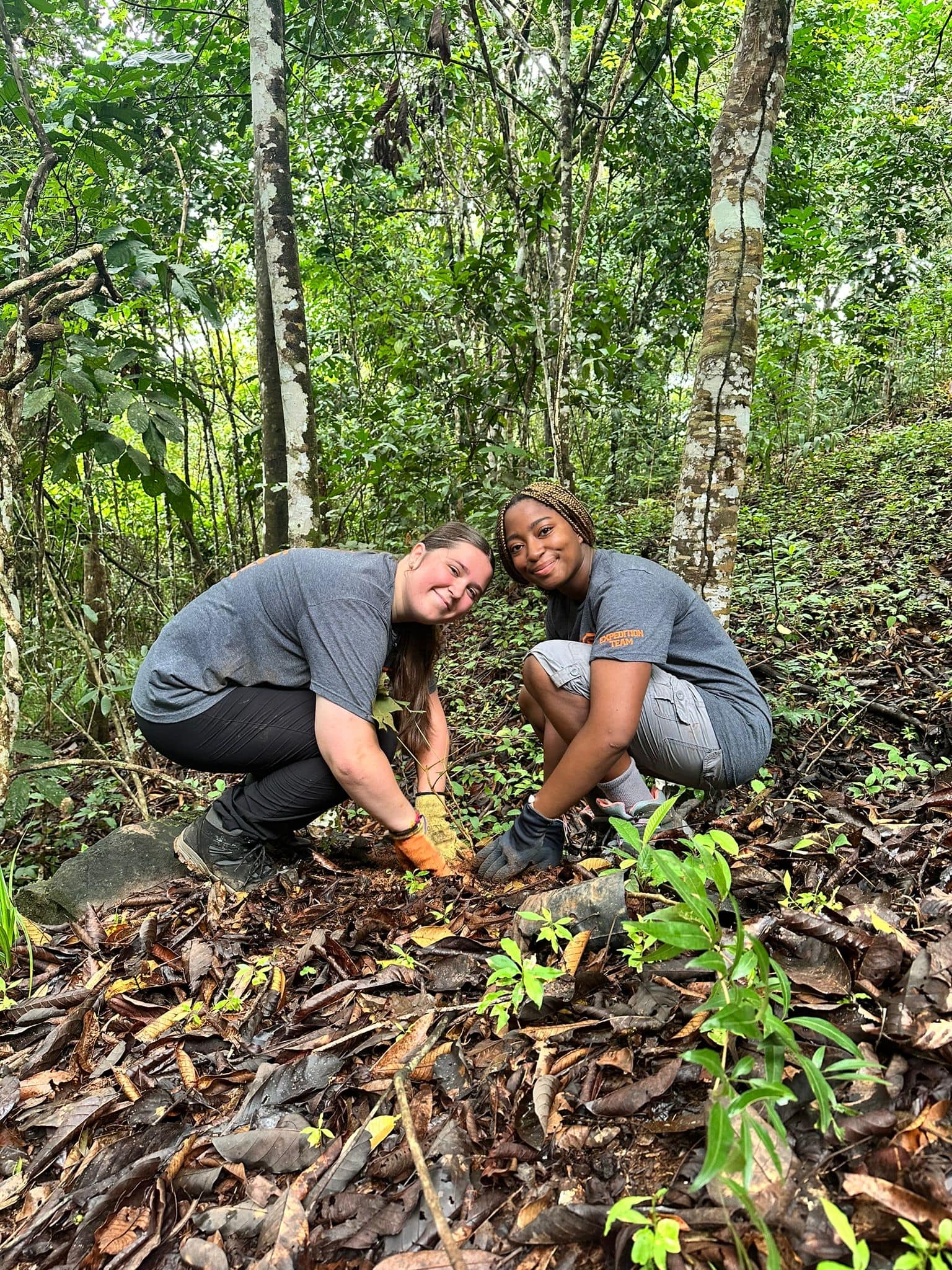 Two students planting trees as part of Camp Costa Rica's regeneration project