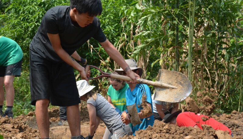 Boy digging at community project in ecuador