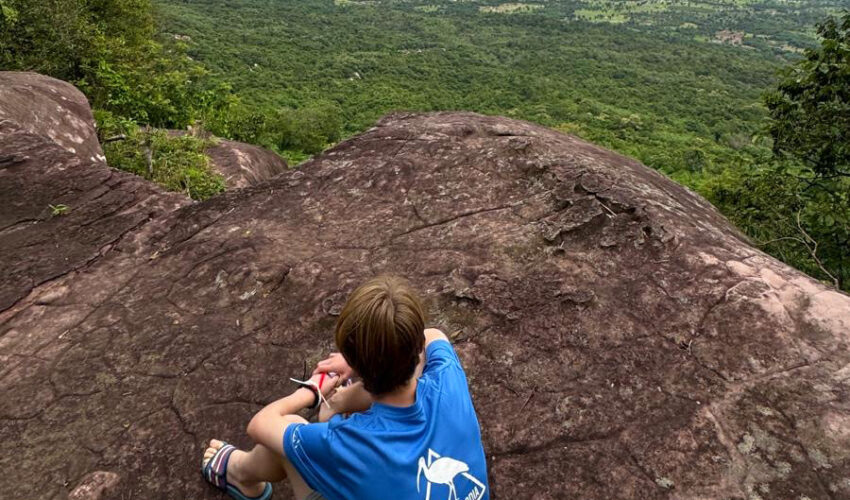 A traveller looking at the view on a trek in Cambodia