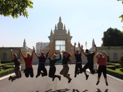 Travellers jumping infront of a temple, Cambodia