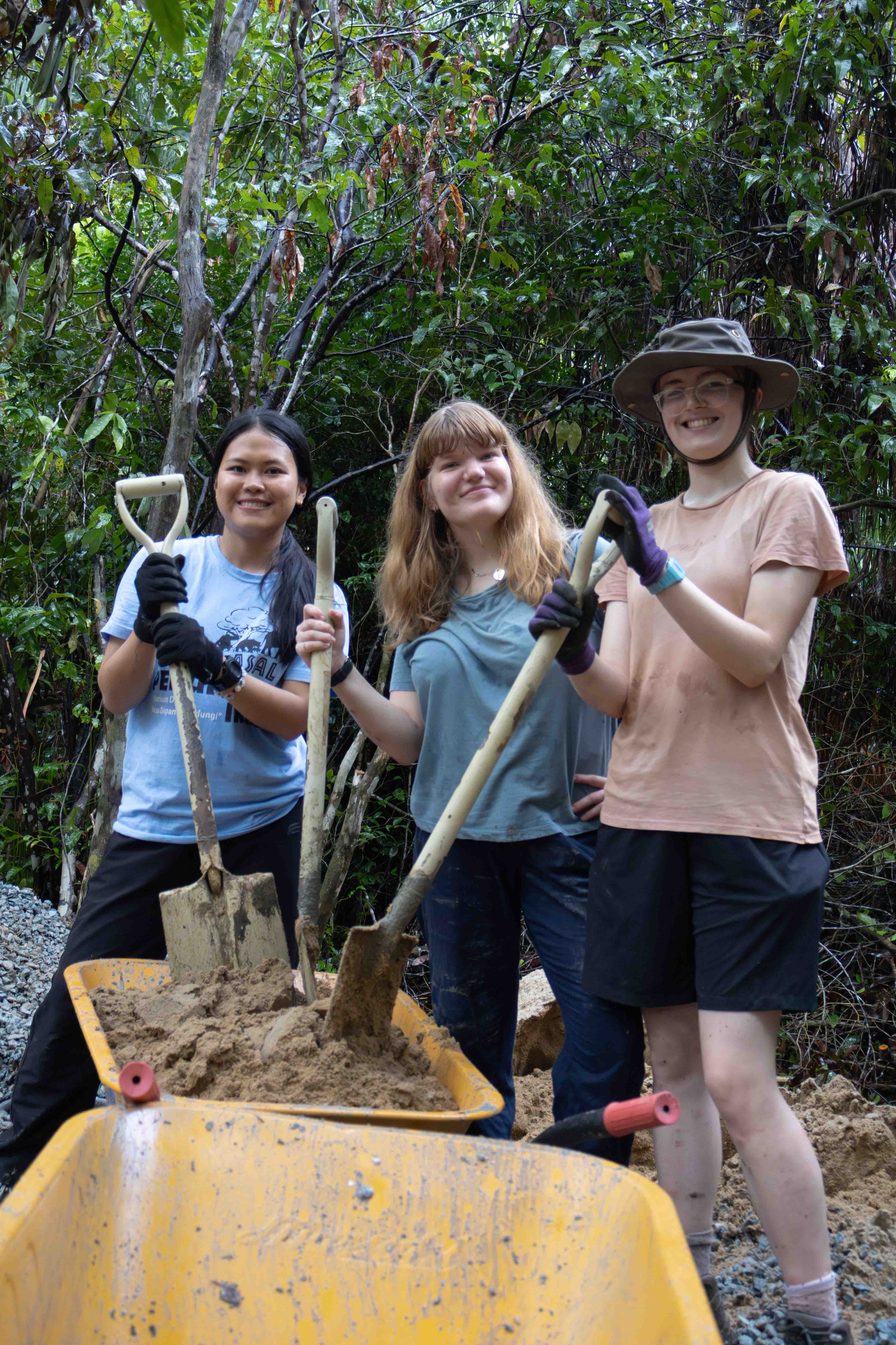 Travellers digging on a project, Borneo