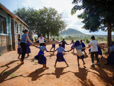 Group of students on a Camps International expedition playing games with the local children and learning lessons beyond the classroom.