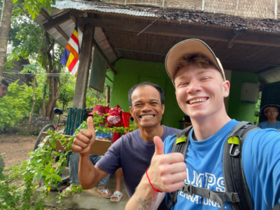 Traveller and a local from Cambodia posing together and smiling