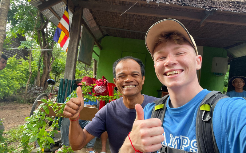 Traveller and a local from Cambodia posing together and smiling