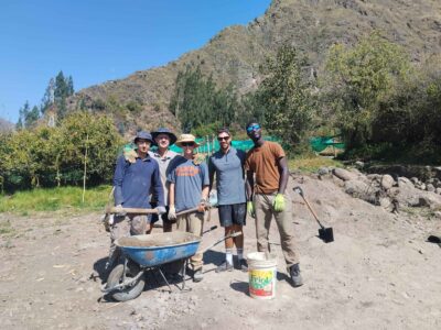 Group of boy travellers on project work site in Peru