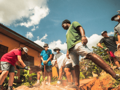 Students travellers doing project work and digging a path in Tanzania