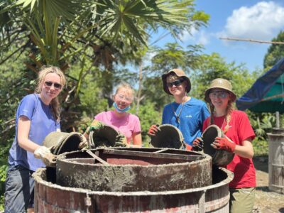 Student travellers smiling and doing project work in Cambodia