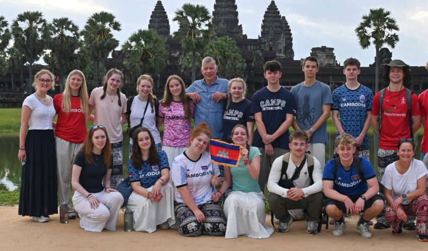 A group photo of student travellers in Cambodia in front of Angkor Wat temple